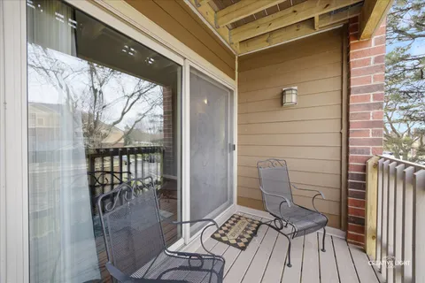 a view of balcony with wooden floor
