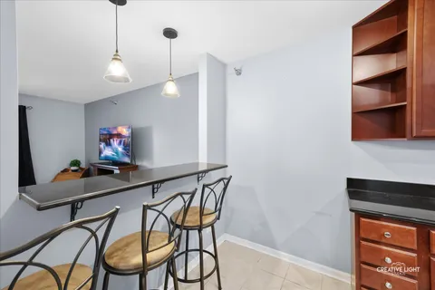 a room with chandelier fan and wooden floor