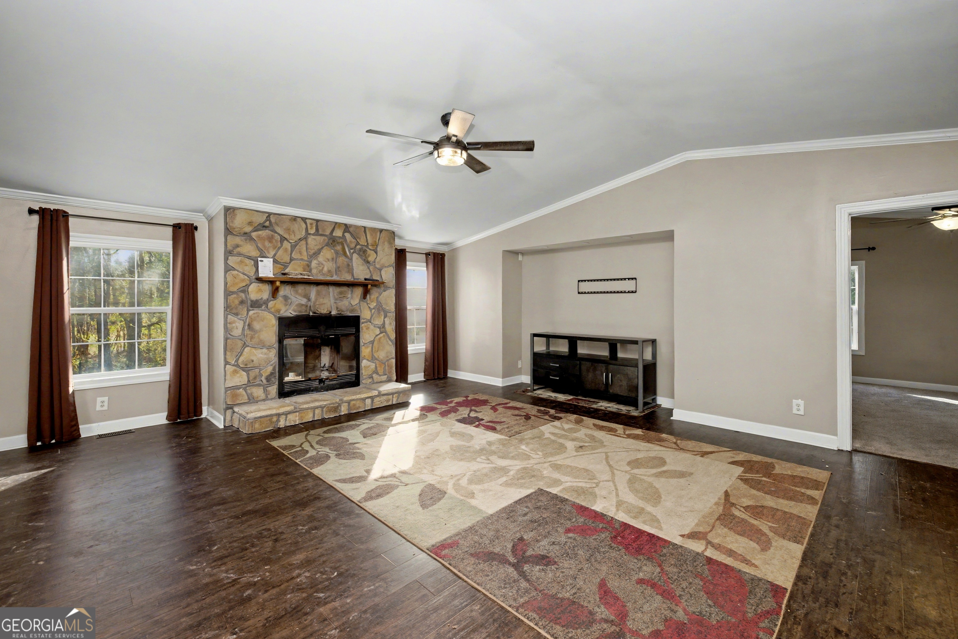 90 Cooksville Road Hogansville, GA 30230 - Photo 5 of 26 an empty room with windows fireplace and wooden floor