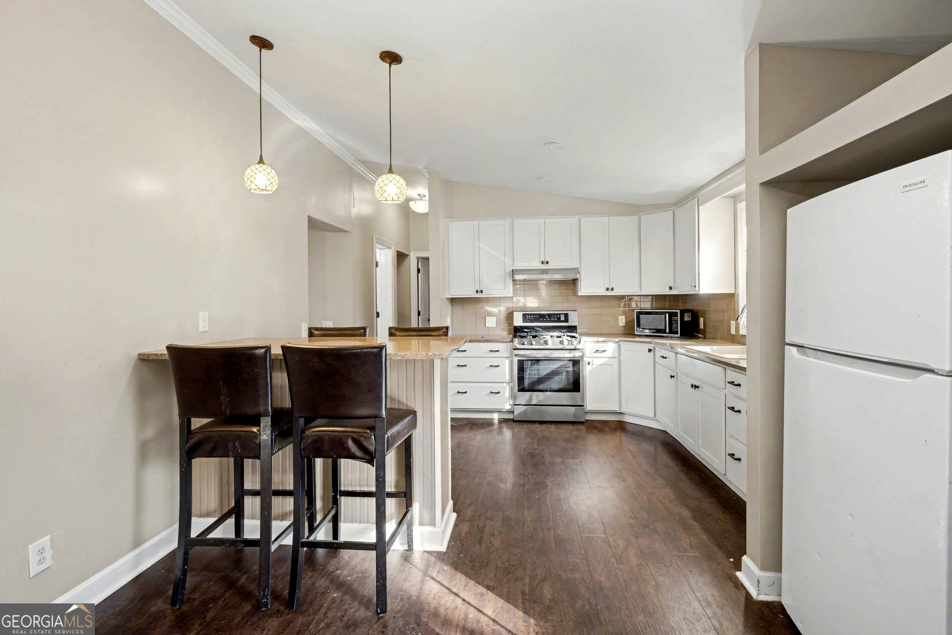 90 Cooksville Road Hogansville, GA 30230 - Photo 8 of 26 a kitchen with a refrigerator a white table and chairs