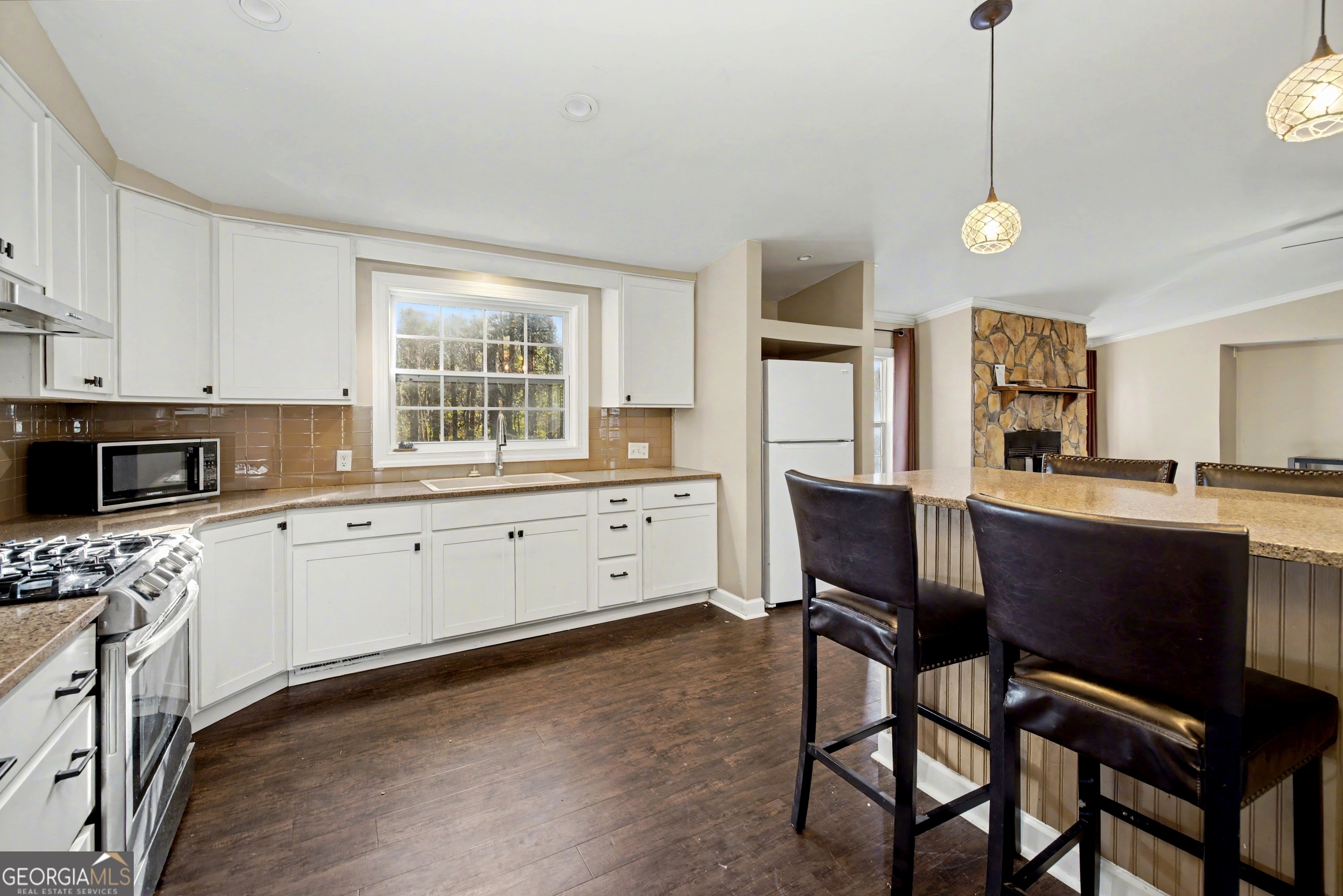 90 Cooksville Road Hogansville, GA 30230 - Photo 9 of 26 a kitchen with a table chairs sink and cabinets