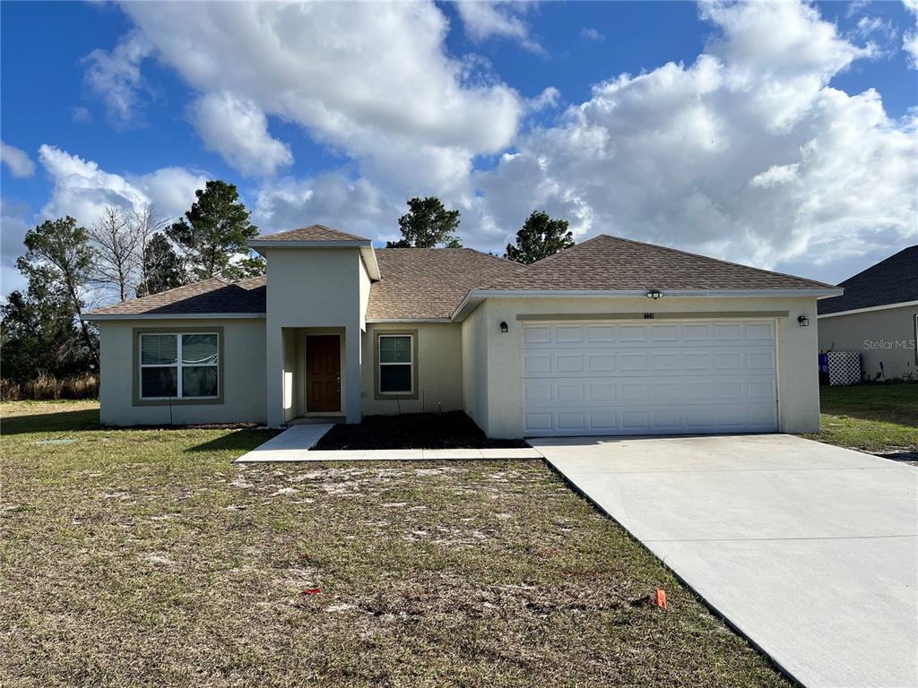 4441 Palmarito Street Sebring, FL 33872 - Photo 1 of 33 a front view of a house with a yard and garage