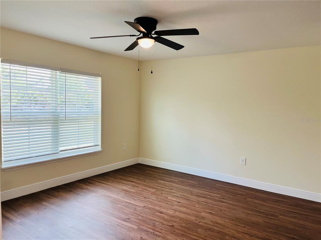 4441 Palmarito Street Sebring, FL 33872 - Photo 12 of 33 a view of empty room with wooden floor and fan