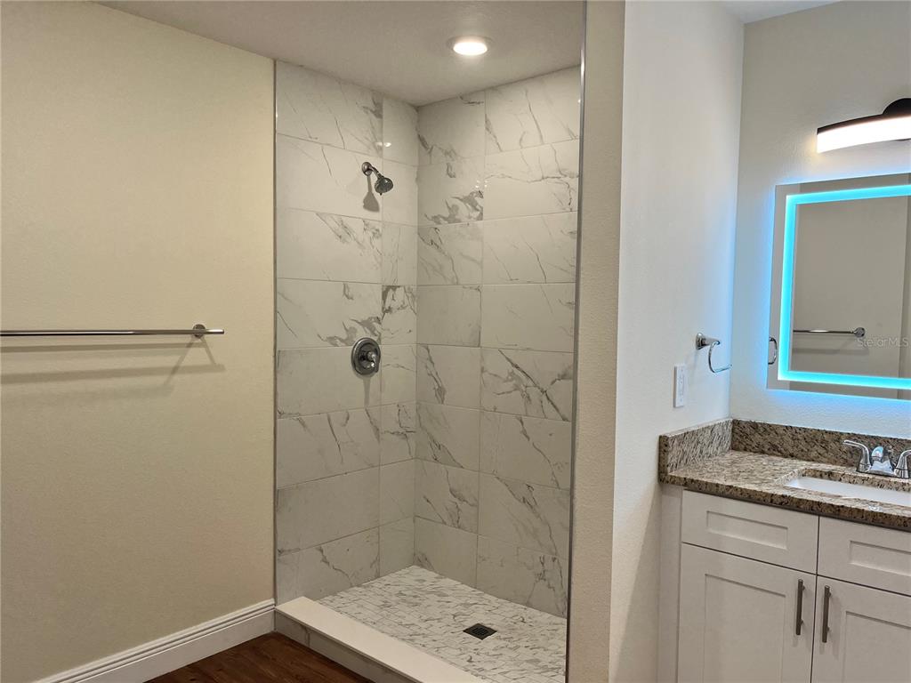 4441 Palmarito Street Sebring, FL 33872 - Photo 14 of 33 a bathroom with a granite countertop shower a sink and a toilet