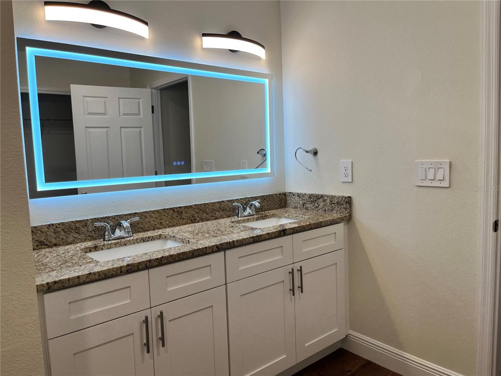 4441 Palmarito Street Sebring, FL 33872 - Photo 17 of 33 a bathroom with a sink and a mirror