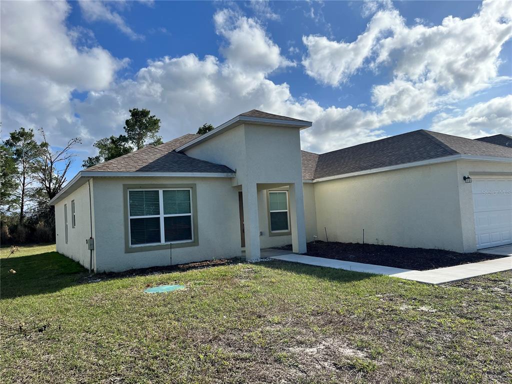 4441 Palmarito Street Sebring, FL 33872 - Photo 2 of 33 a view of a house with a garden