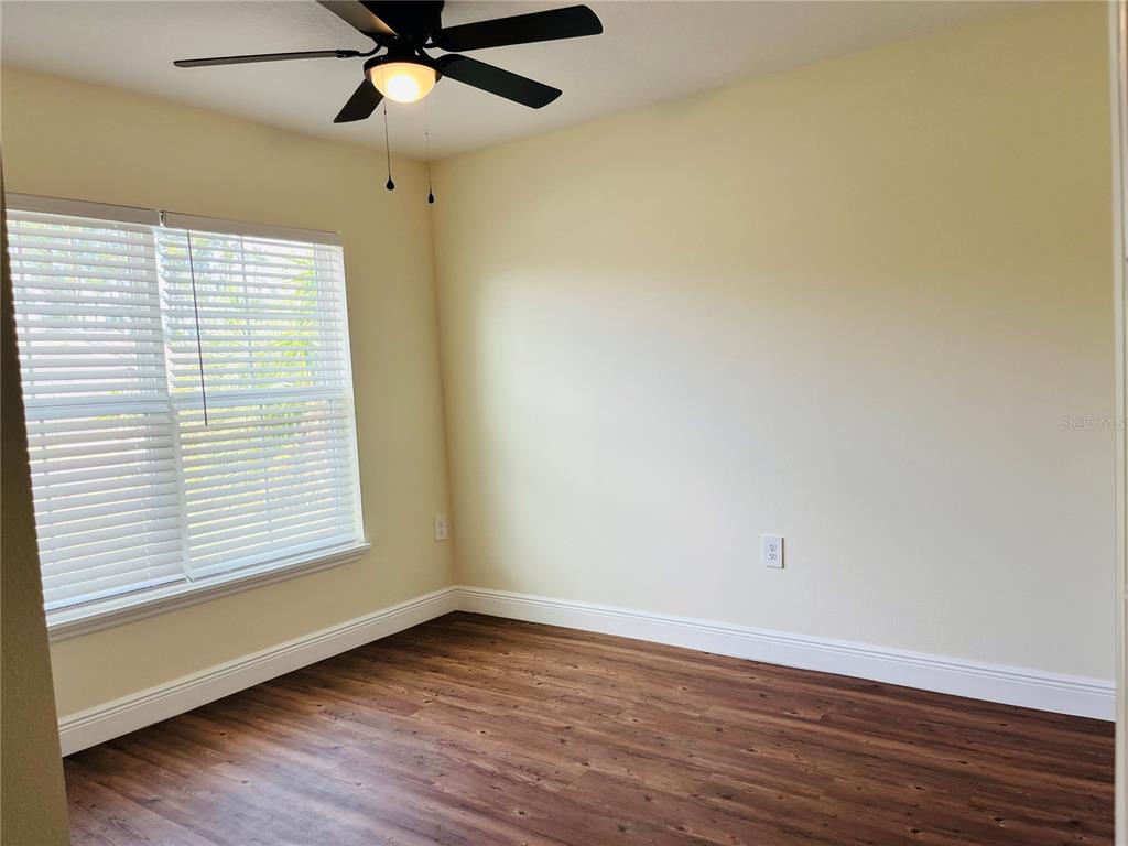4441 Palmarito Street Sebring, FL 33872 - Photo 21 of 33 wooden floor in an empty room with a window