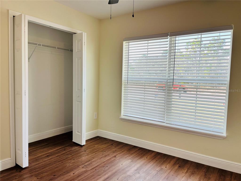 4441 Palmarito Street Sebring, FL 33872 - Photo 22 of 33 a view of an empty room with wooden floor and a window