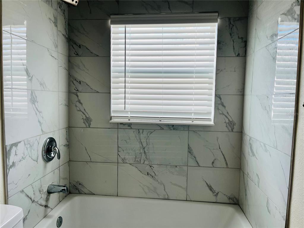 4441 Palmarito Street Sebring, FL 33872 - Photo 24 of 33 a bathroom with a bathtub