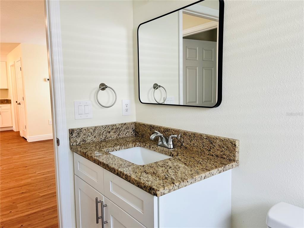 4441 Palmarito Street Sebring, FL 33872 - Photo 25 of 33 a bathroom with a granite countertop sink and a mirror