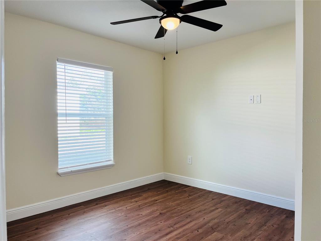 4441 Palmarito Street Sebring, FL 33872 - Photo 26 of 33 wooden floor in an empty room with a window