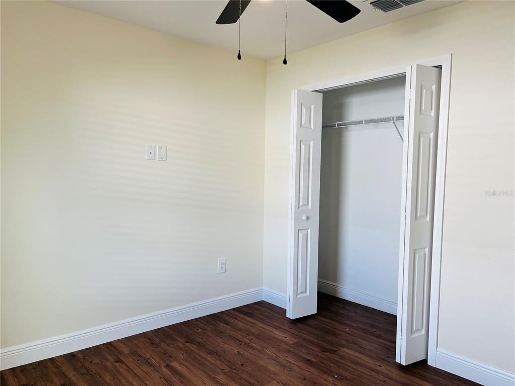 4441 Palmarito Street Sebring, FL 33872 - Photo 27 of 33 a view of an empty room with wooden floor