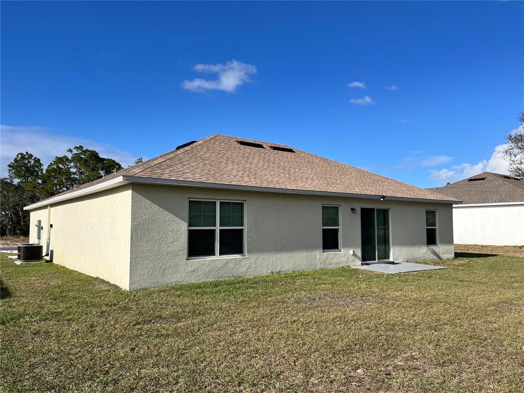 4441 Palmarito Street Sebring, FL 33872 - Photo 4 of 33 a house with yard in front of it