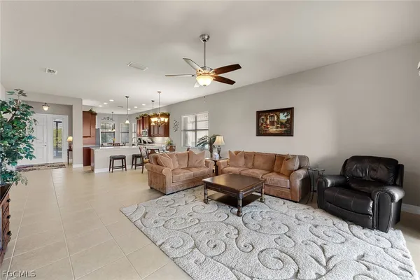 a living room with furniture or couch and a ceiling fan