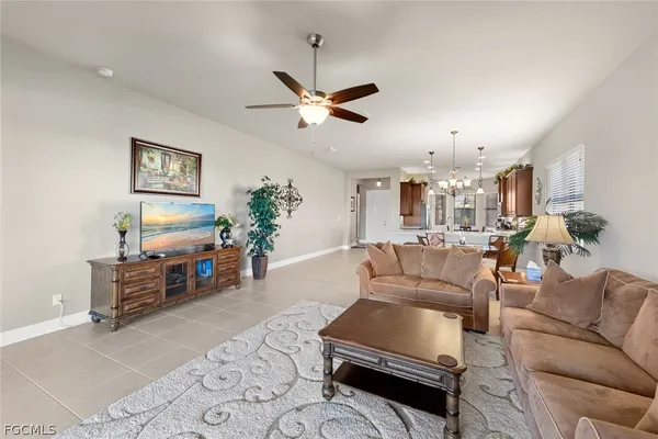 a living room with furniture and a chandelier