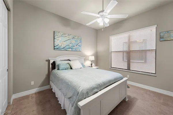 a large bed sitting in a bedroom next to a window