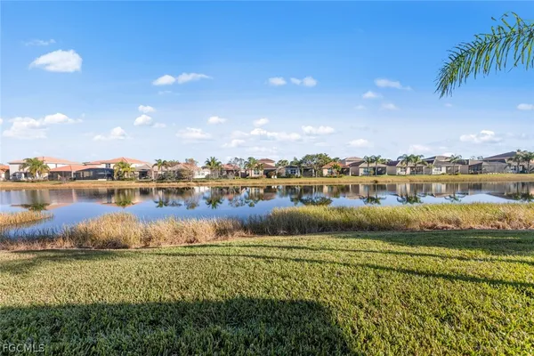 a view of a lake with houses in the back