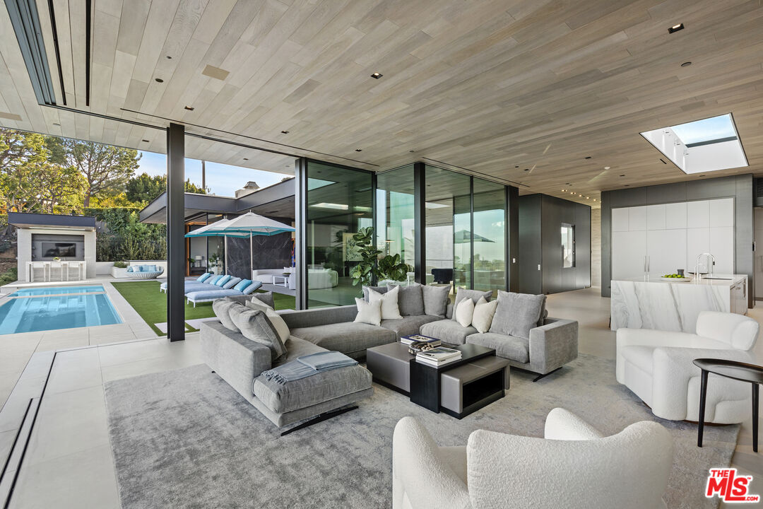 445 Walker Drive Beverly Hills, CA 90210 - Photo 11 of 30 a living room with furniture and a large window
