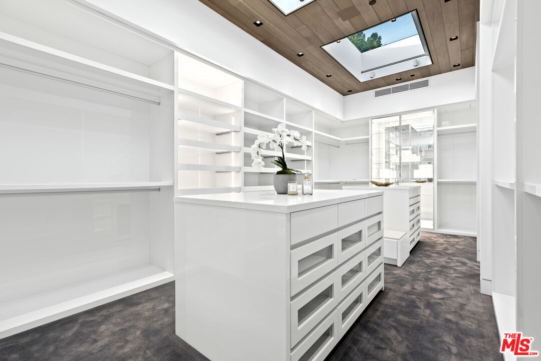 445 Walker Drive Beverly Hills, CA 90210 - Photo 17 of 30 a kitchen with kitchen island a sink stove and cabinets