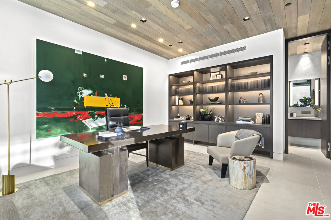 445 Walker Drive Beverly Hills, CA 90210 - Photo 19 of 30 a room with lots of furniture and mirrors