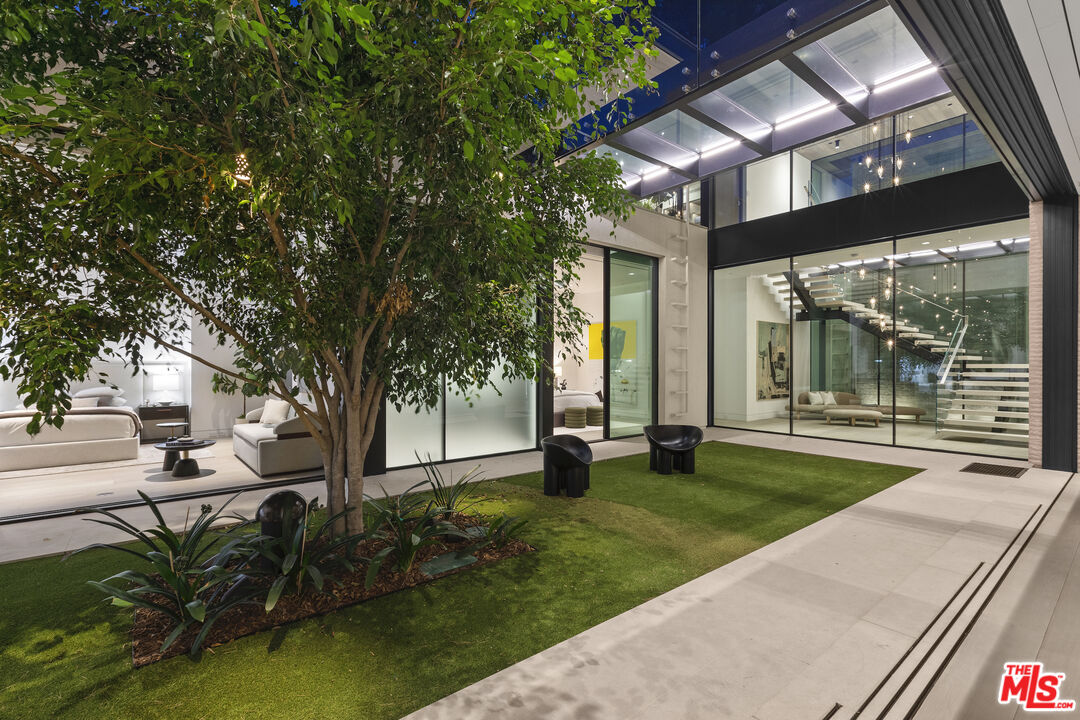 445 Walker Drive Beverly Hills, CA 90210 - Photo 24 of 30 a view of a house with backyard sitting area and garden