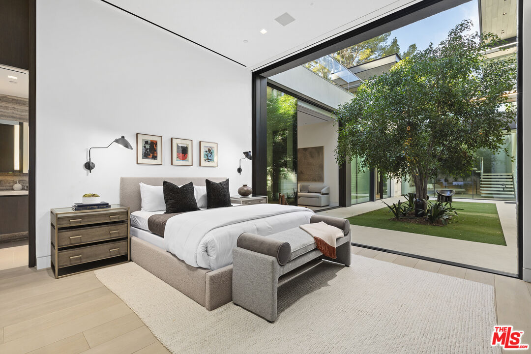 445 Walker Drive Beverly Hills, CA 90210 - Photo 28 of 30 a bed room with a bed and a large window