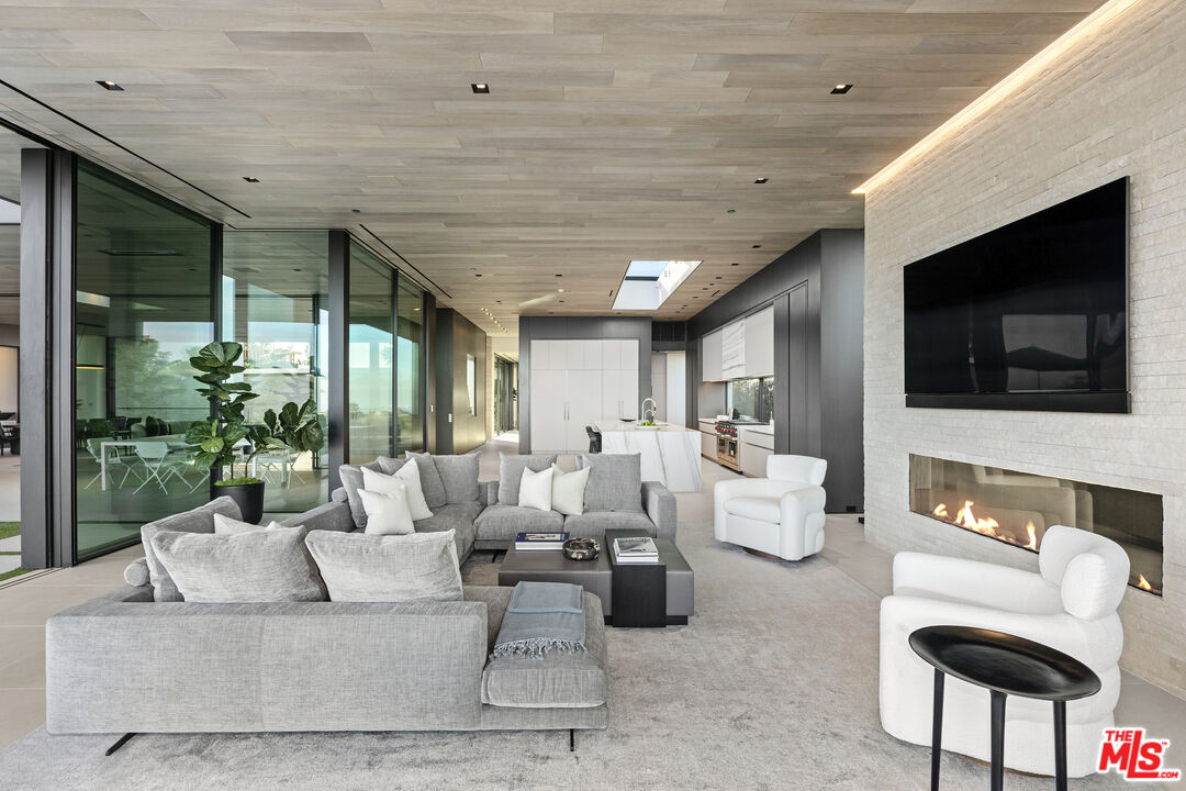 445 Walker Drive Beverly Hills, CA 90210 - Photo 10 of 30 a living room with furniture and a flat screen tv