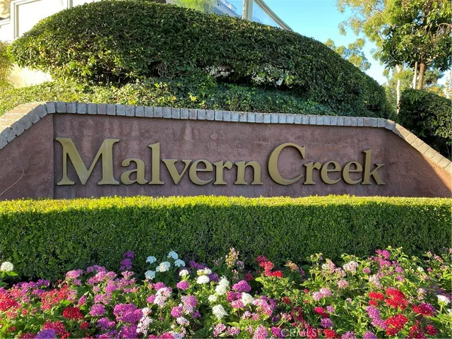 a sign that is in front of flowers