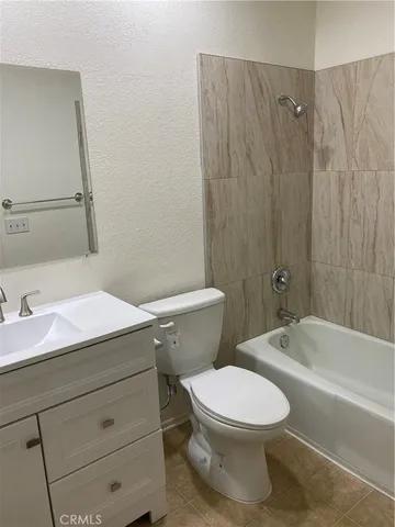 a bathroom with a toilet a sink and bathtub