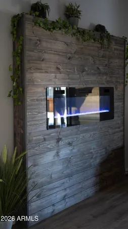 a view of a living room with a flat screen tv and floor to ceiling window
