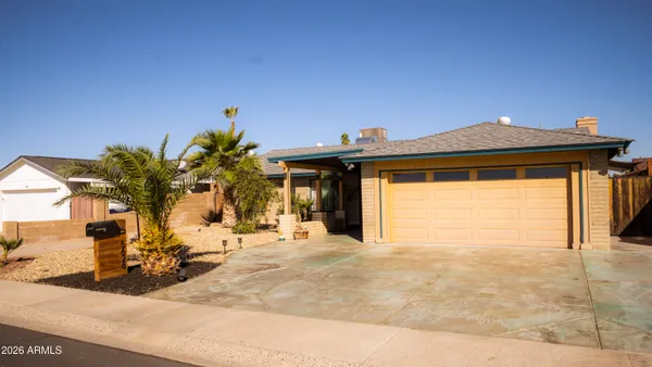 a view of a house with a small yard