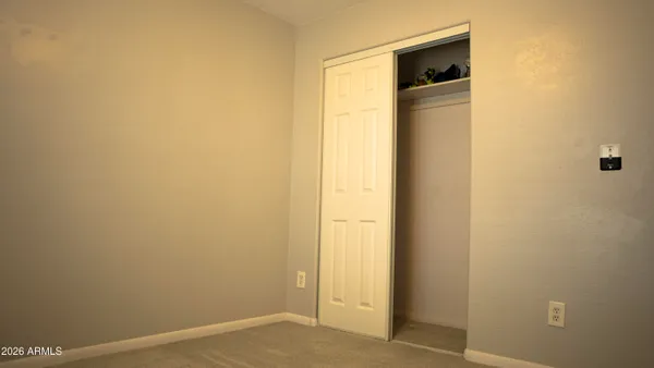 a bedroom with a bed window and a tv