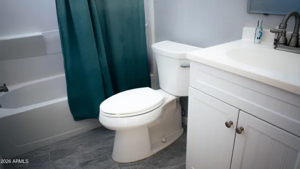 a bathroom with a toilet sink and shower