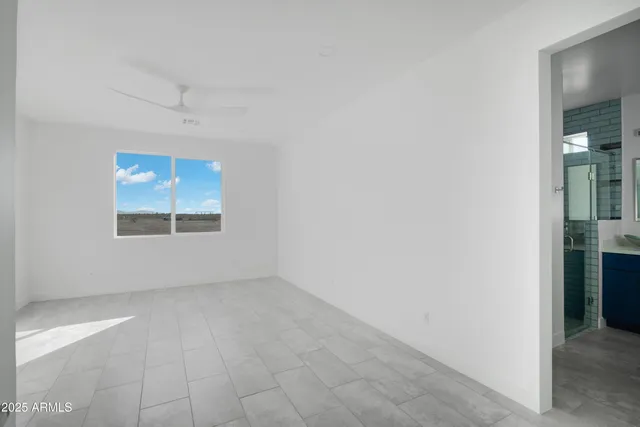 an empty room with windows and closet