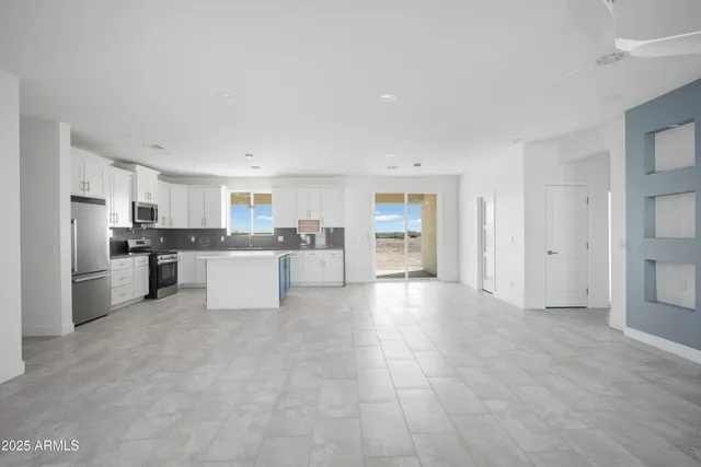 a view of kitchen with refrigerator sink and cabinets