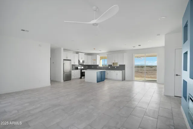 a large white kitchen with a sink and cabinets
