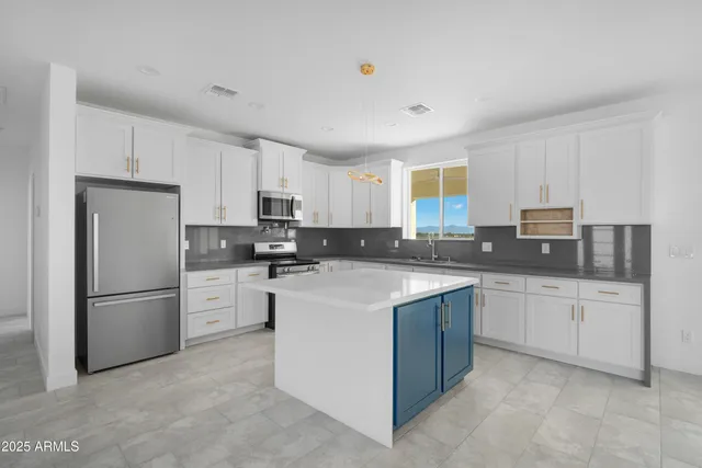 a kitchen with granite countertop cabinets stainless steel appliances and a counter space