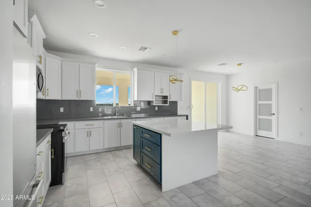 a kitchen with granite countertop white cabinets and white appliances