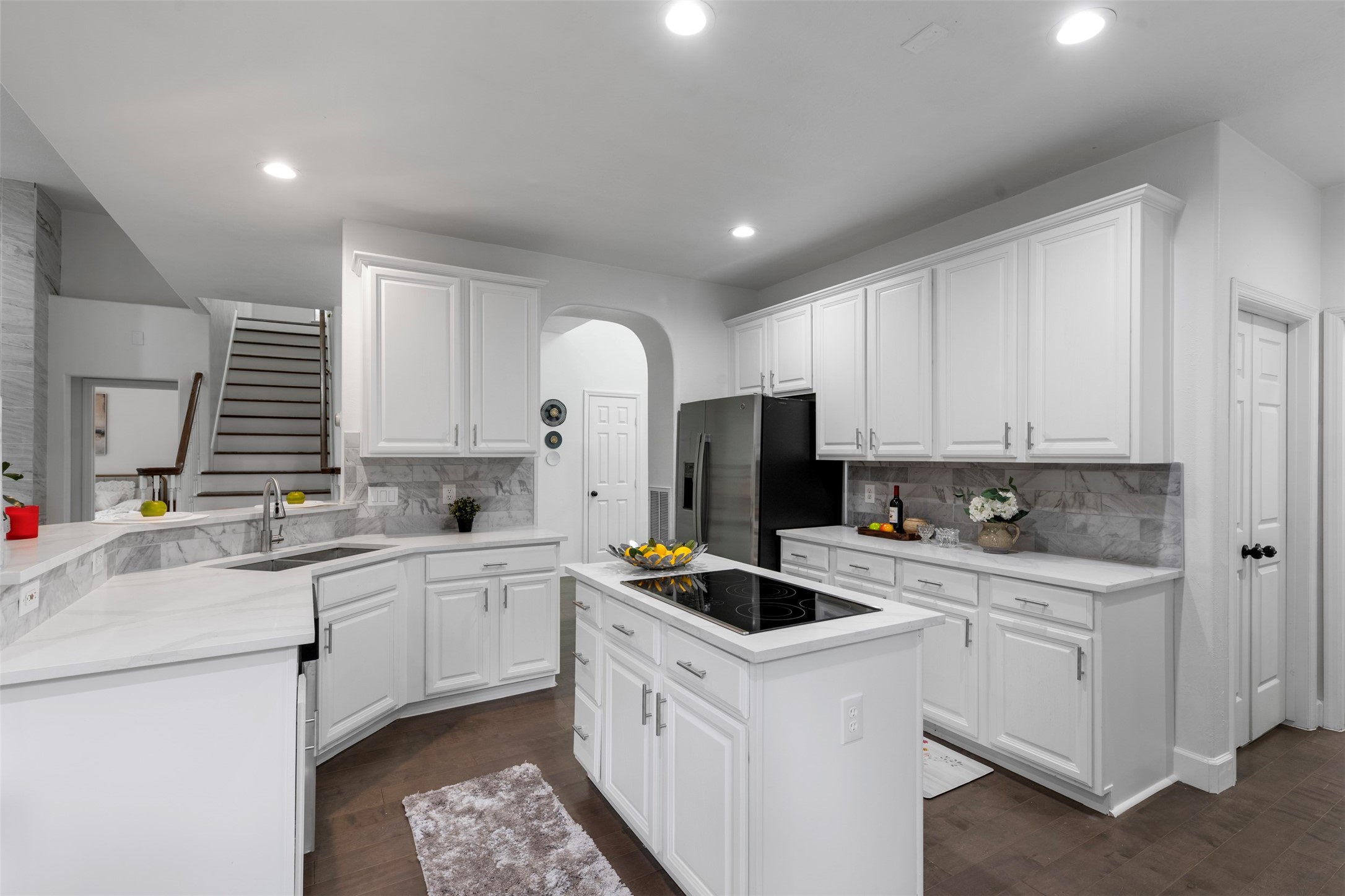 55 Terraglen Drive Spring, TX 77382 - Photo 6 of 33 a kitchen with a sink a refrigerator and white cabinets