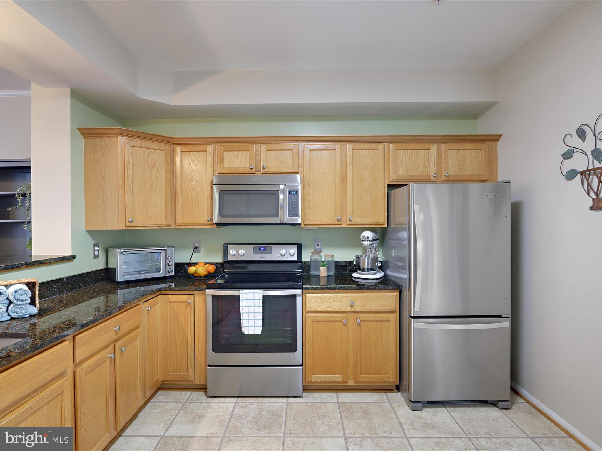 2355 Sandy Walk Way Odenton, MD 21113 - Photo 11 of 68 a kitchen with stainless steel appliances granite countertop a refrigerator sink stove microwave and cabinets
