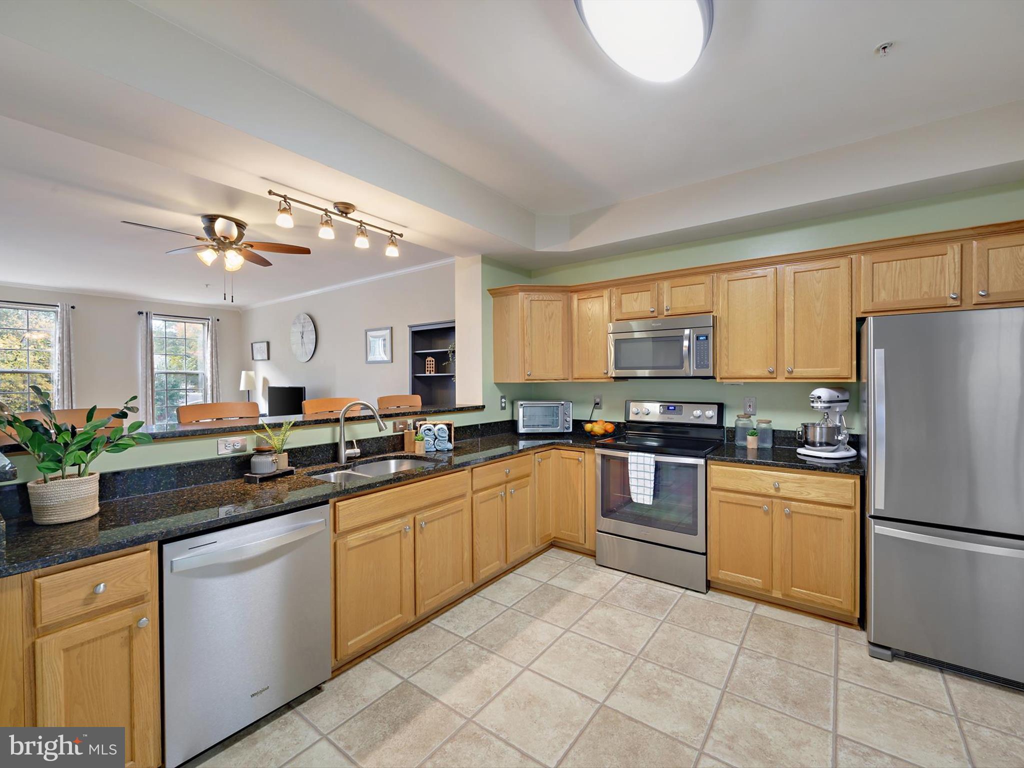 2355 Sandy Walk Way Odenton, MD 21113 - Photo 12 of 68 a kitchen with stainless steel appliances granite countertop a stove sink and refrigerator