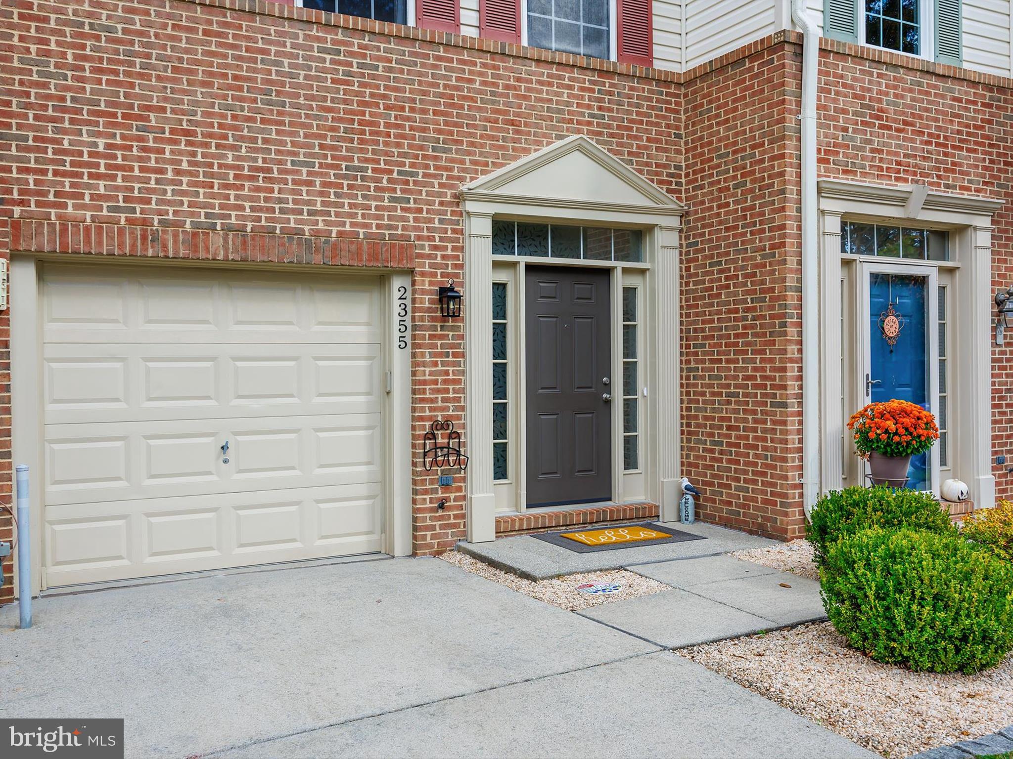 2355 Sandy Walk Way Odenton, MD 21113 - Photo 2 of 68 a view of a brick house with potted plants