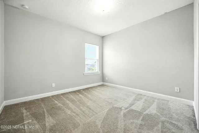 a kitchen with kitchen island granite countertop a sink cabinets and refrigerator