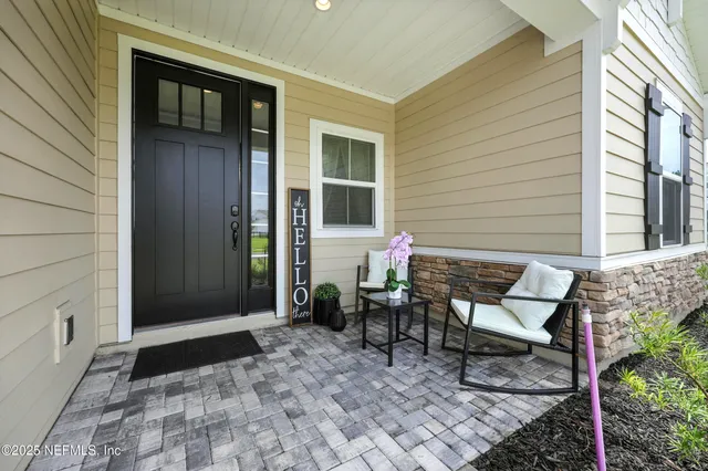 a view of a house with backyard and sitting area