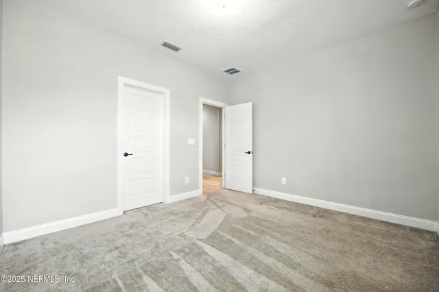 a kitchen with stainless steel appliances granite countertop a stove top oven a dining table and chairs