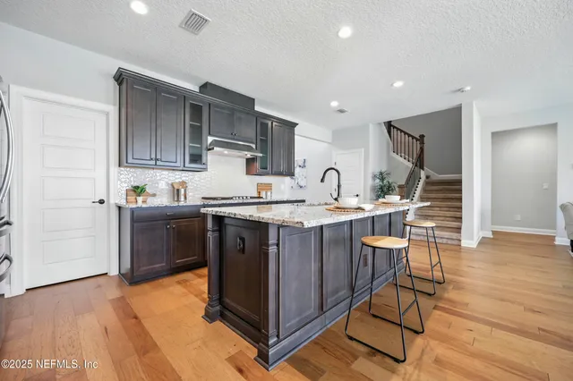 a living room with furniture wooden floor and a large window