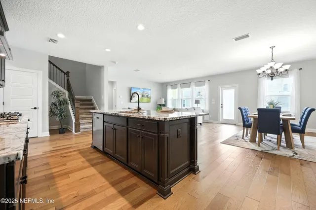 a living room with furniture and kitchen view