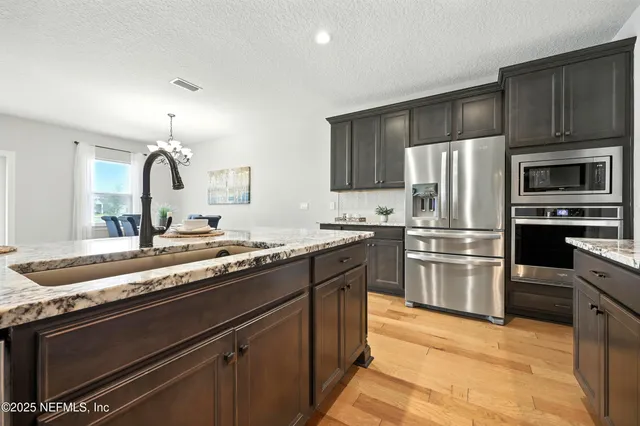 a view of a dining room with furniture and chandelier