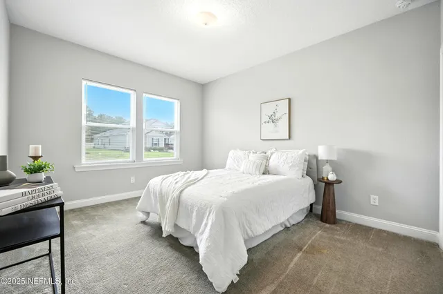 a bed room with a bed and a window