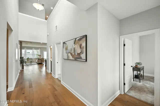 a bedroom with a bed and painting on the wall